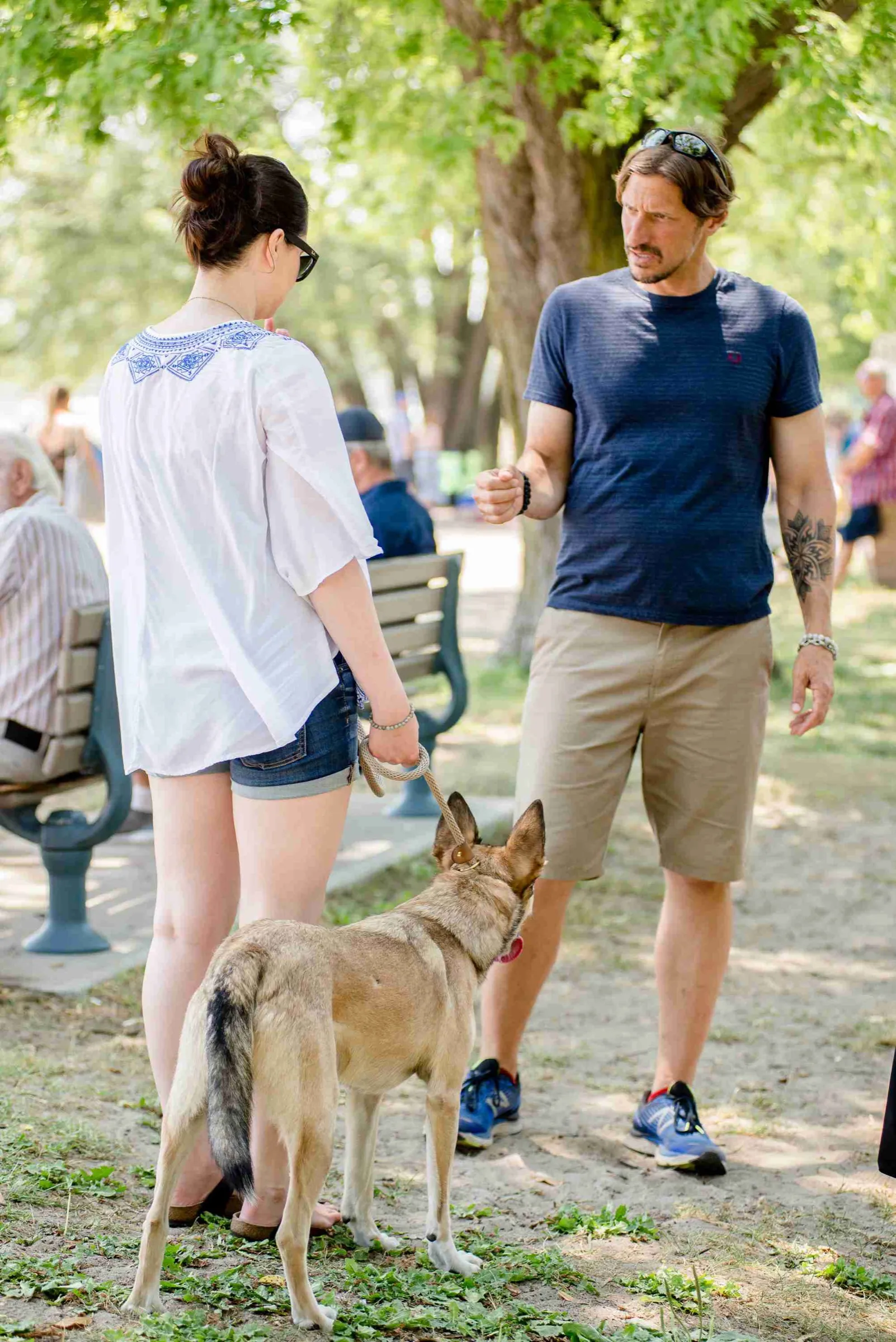 Mark talking an owner through her dog's guarding in a Toronto park, the dog calm at their feet